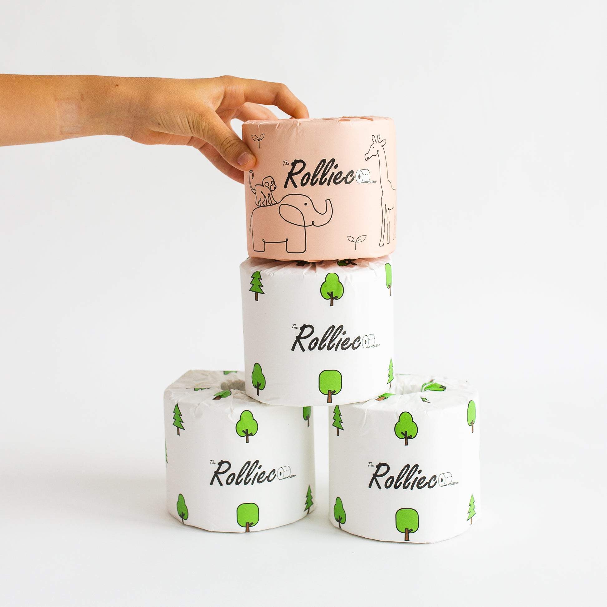 4 rolls of eco toilet papers stacked in a pyramid manner with a hand picking the top one