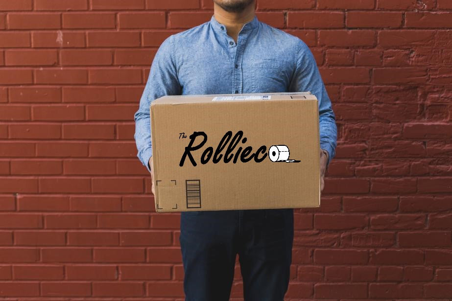 Delivery man in blue shirt holding a carton box parcel branded The Rollieco